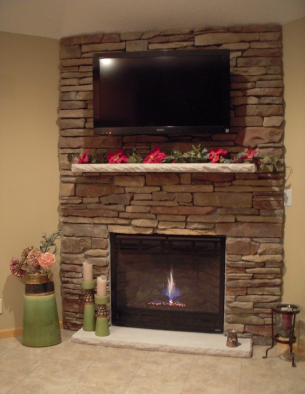 Stone fireplace with mounted TV